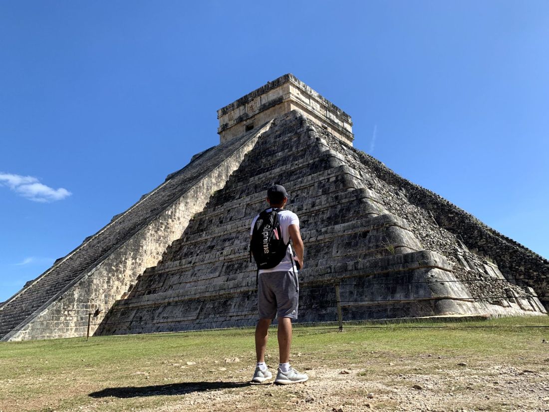 Standing at the base of the stepped pyramid at Chichén Itzá