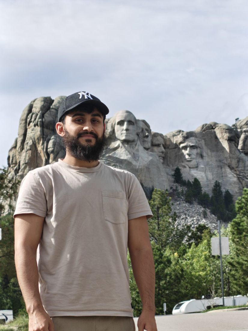 Standing in front of the Mount Rushmore carvings